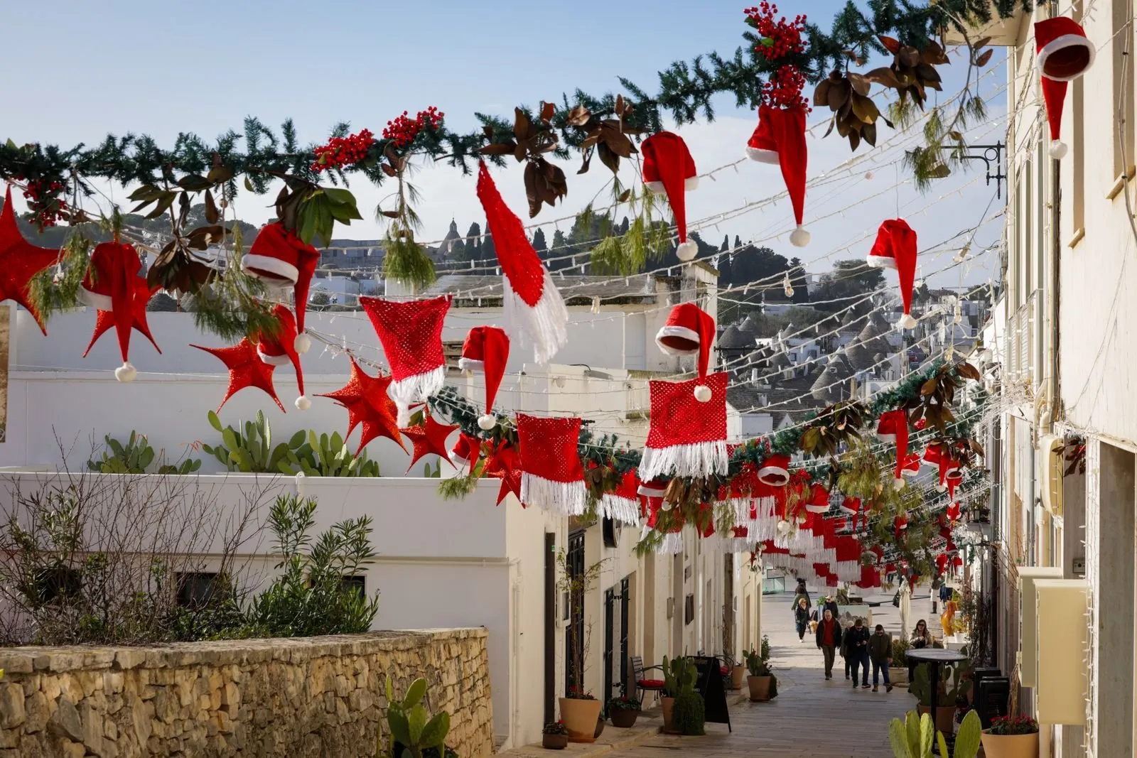 Christmas decorations strung over a whitewashed village lane